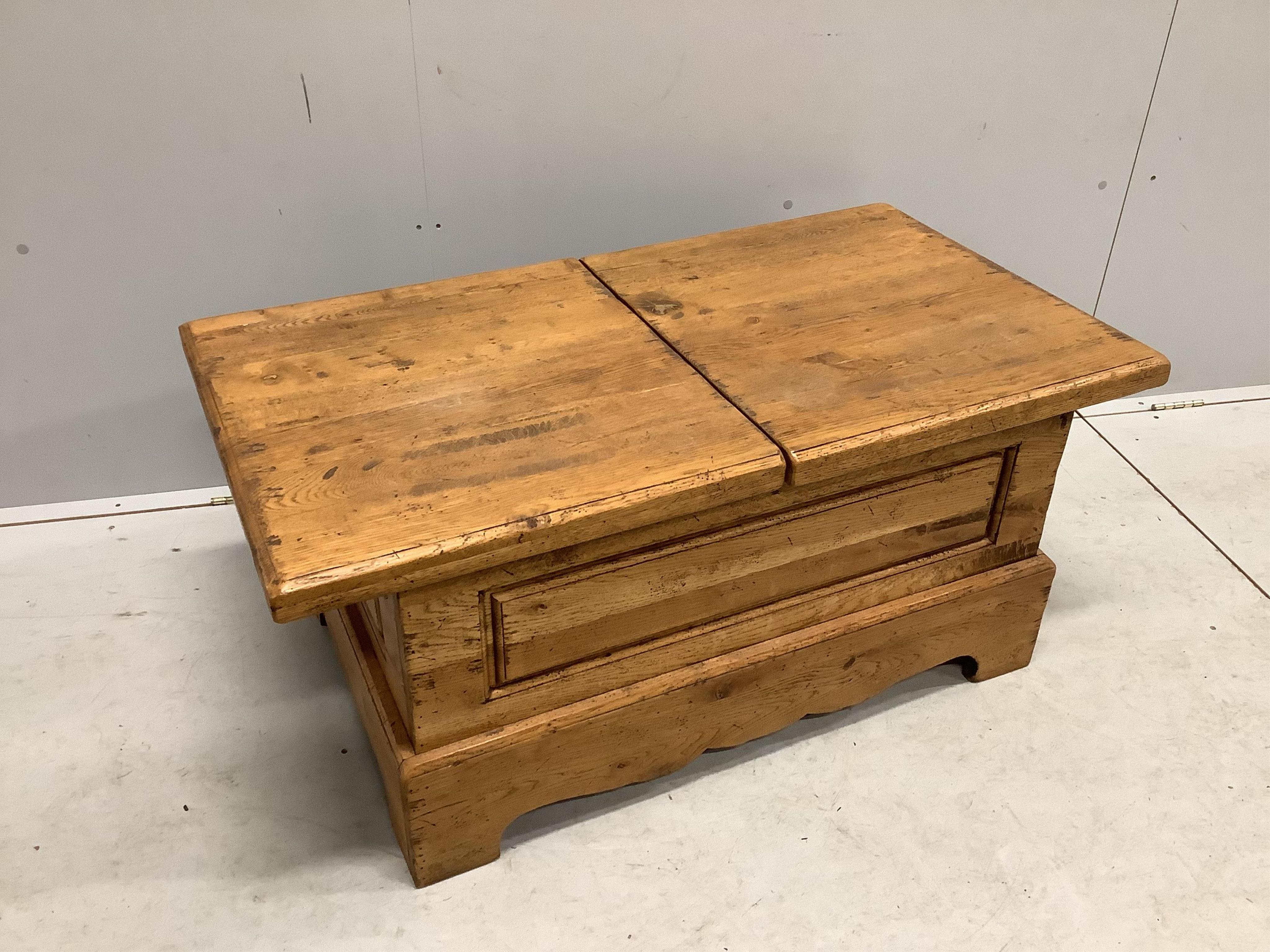 A Wesley Barrel pale oak twin hinged flap top storage coffee table, width 110cm, depth 60cm, height 48cm. Condition - fair